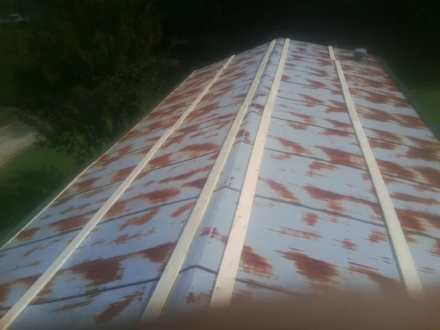 Rusted metal roof panels with new wood purlins before replacement — Storm Damage Roof Repair in Berea by Roofing Brothers